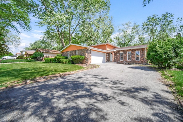 ranch-style home with a garage and a front yard