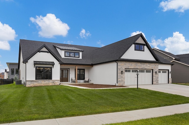 view of front facade with central AC, a front yard, and a garage