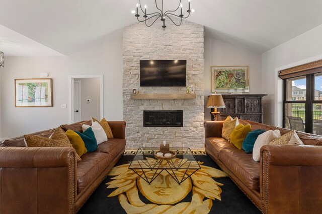 living room featuring a notable chandelier, vaulted ceiling, and a fireplace