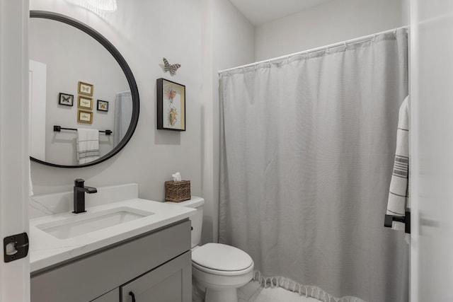 bathroom with tile flooring, vanity, and toilet