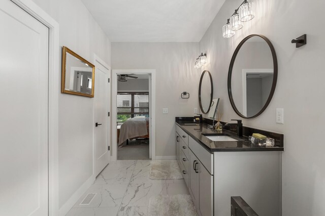 bathroom with double sink vanity, ceiling fan, and tile floors