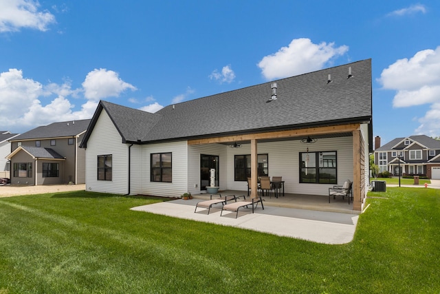 rear view of house featuring a yard, ceiling fan, central AC unit, and a patio