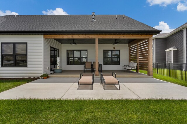 rear view of house with a patio, a lawn, and ceiling fan