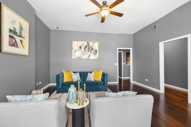 living room featuring dark wood-type flooring and ceiling fan