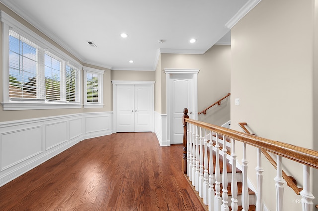 hallway with dark hardwood / wood-style floors and crown molding