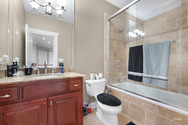 full bathroom with a chandelier, enclosed tub / shower combo, toilet, tile floors, and vanity