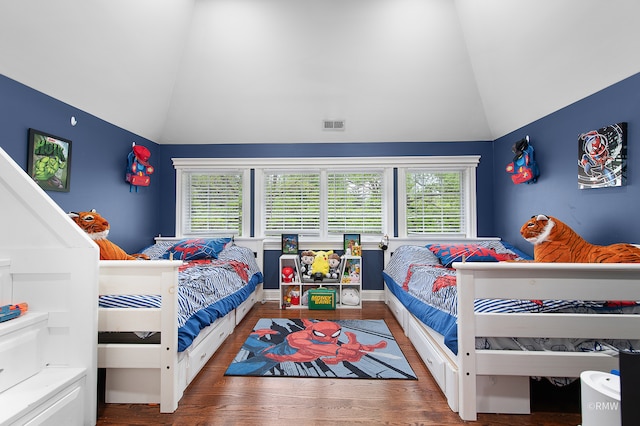 bedroom with wood-type flooring and vaulted ceiling