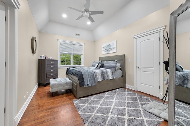 bedroom with ceiling fan, hardwood / wood-style floors, and lofted ceiling