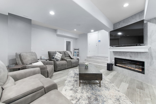 living room with a premium fireplace and light hardwood / wood-style flooring