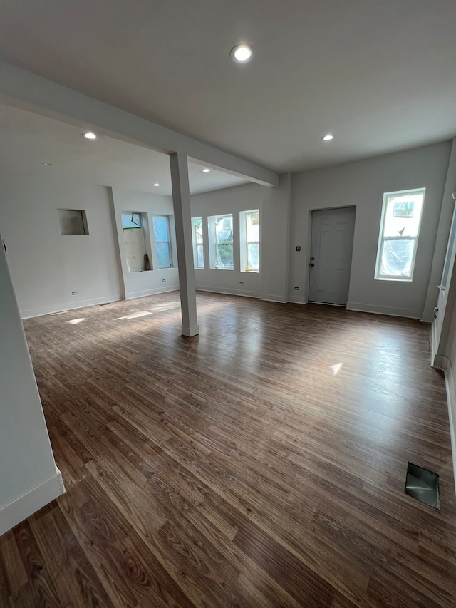 unfurnished living room featuring dark hardwood / wood-style flooring