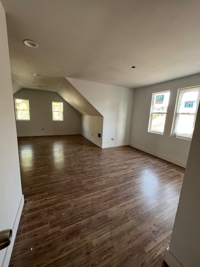 empty room featuring dark hardwood / wood-style floors and vaulted ceiling