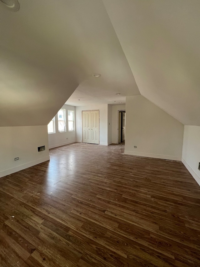 bonus room featuring dark hardwood / wood-style flooring and lofted ceiling