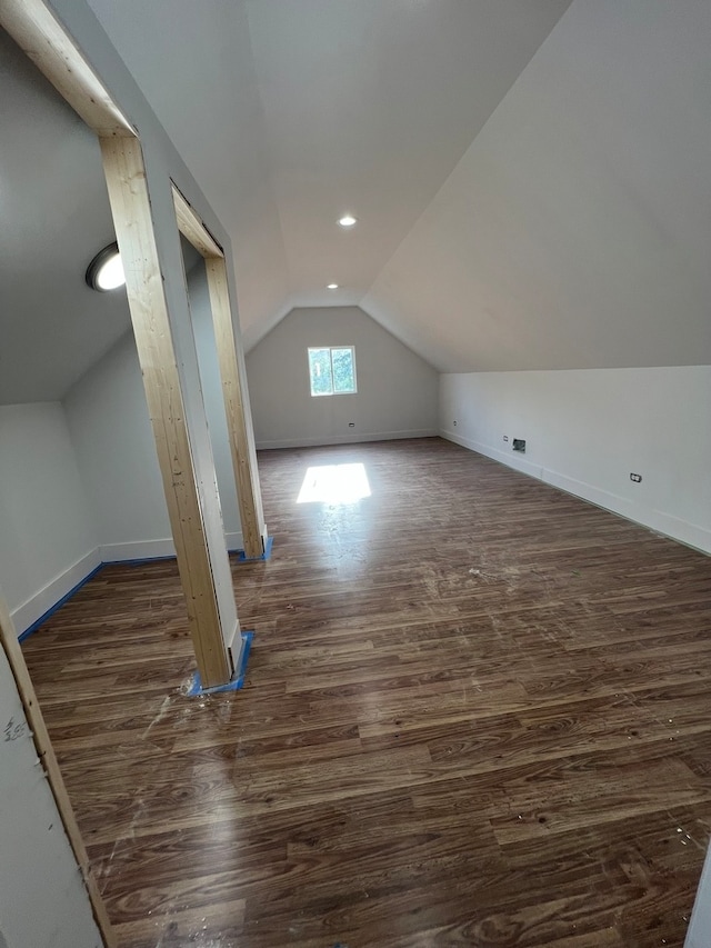 bonus room featuring dark hardwood / wood-style floors and vaulted ceiling