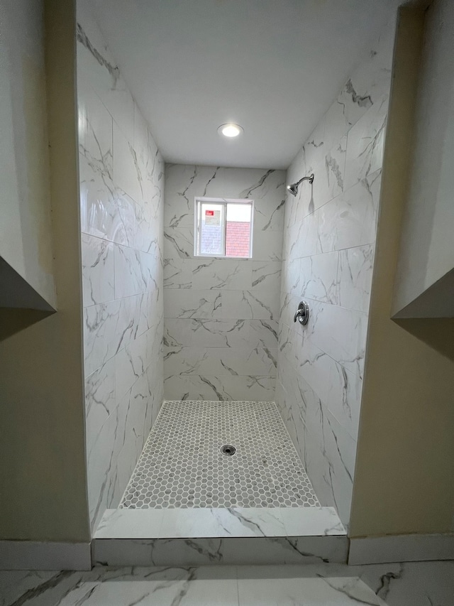 bathroom featuring a tile shower and tile floors