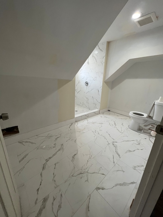 bathroom featuring tile flooring, a shower, and toilet