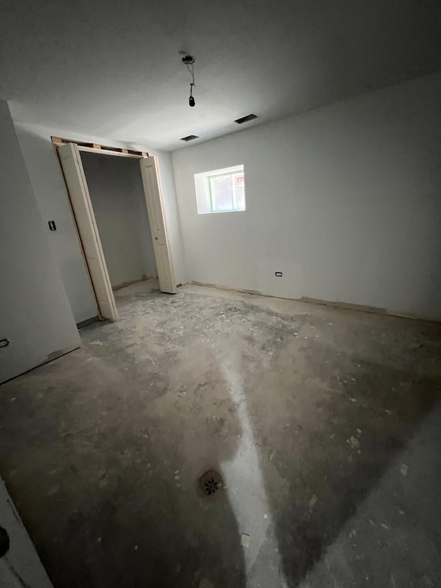 unfurnished bedroom with concrete floors