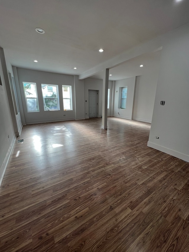 unfurnished living room featuring dark hardwood / wood-style flooring