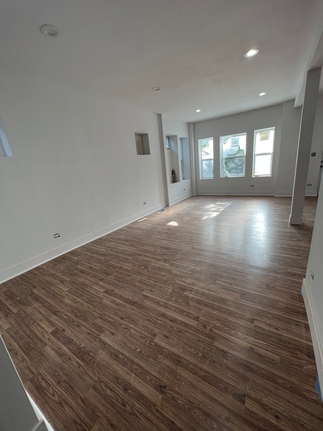 unfurnished living room featuring dark hardwood / wood-style floors