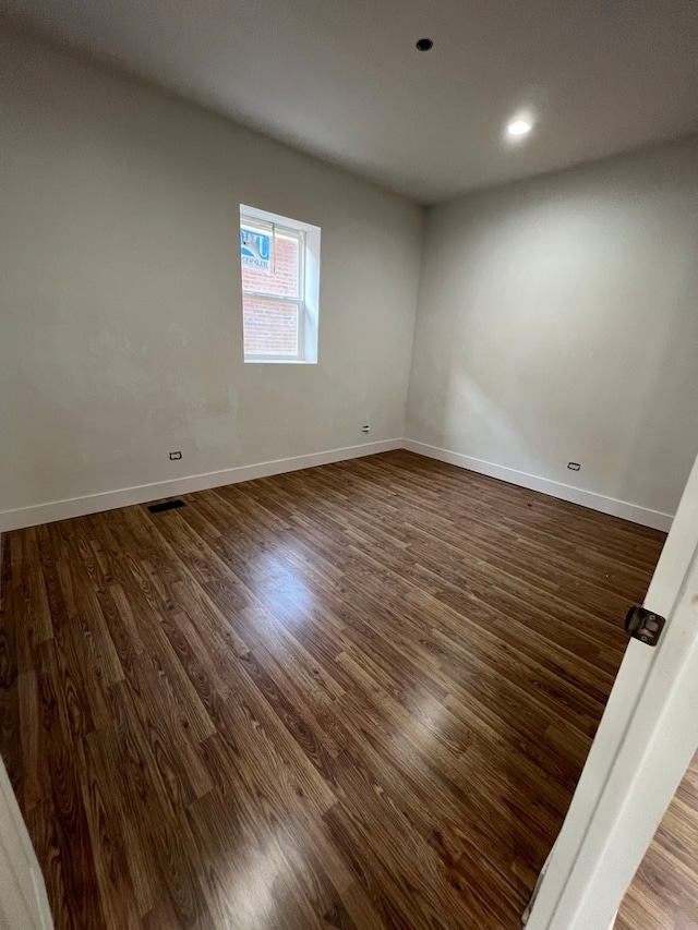 unfurnished room with dark hardwood / wood-style floors