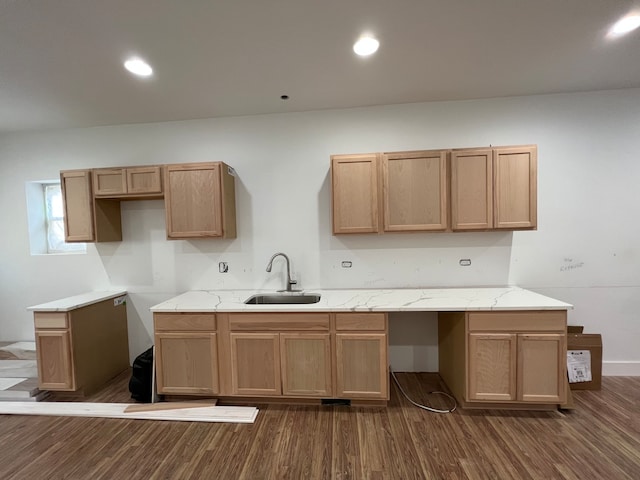 kitchen featuring sink, light stone counters, and dark hardwood / wood-style flooring