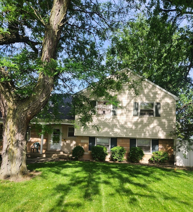 split level home featuring a front lawn