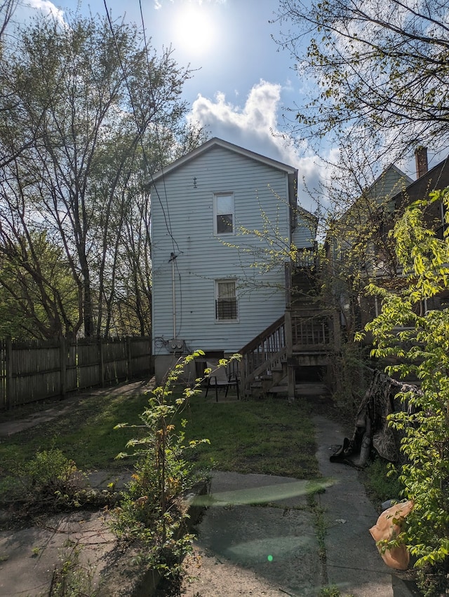 rear view of property featuring a yard