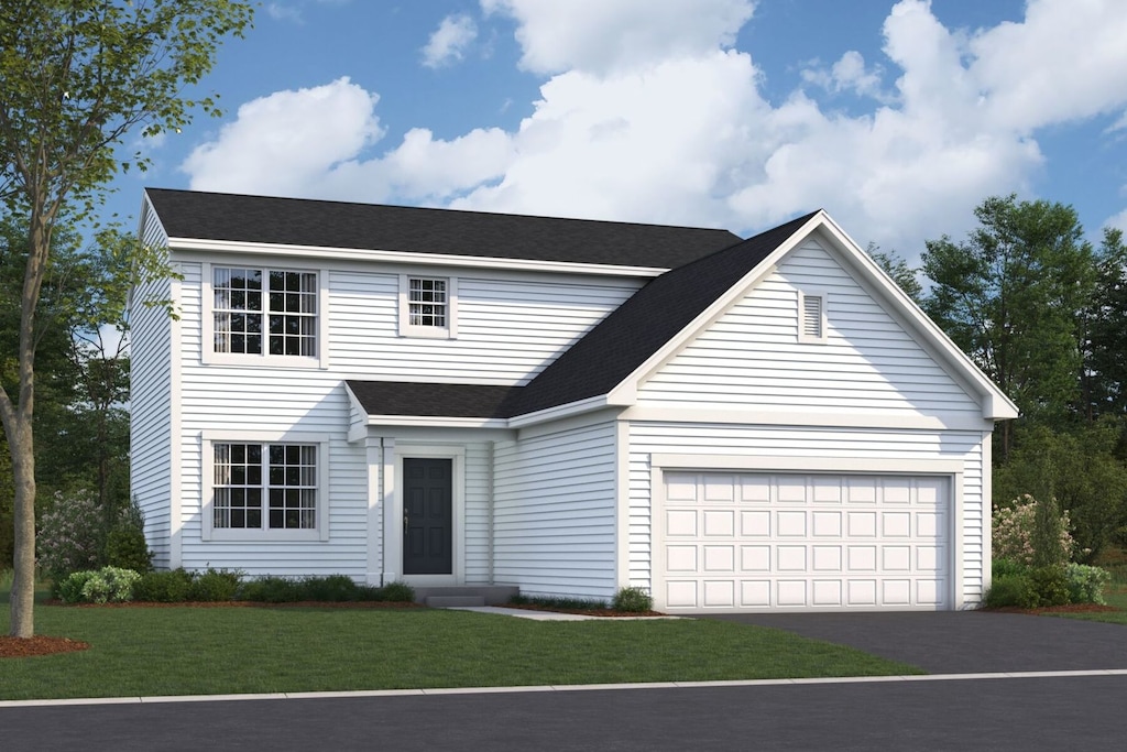 view of front of house with a front yard and a garage