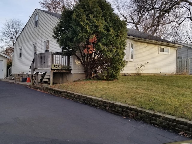 view of side of home with a lawn