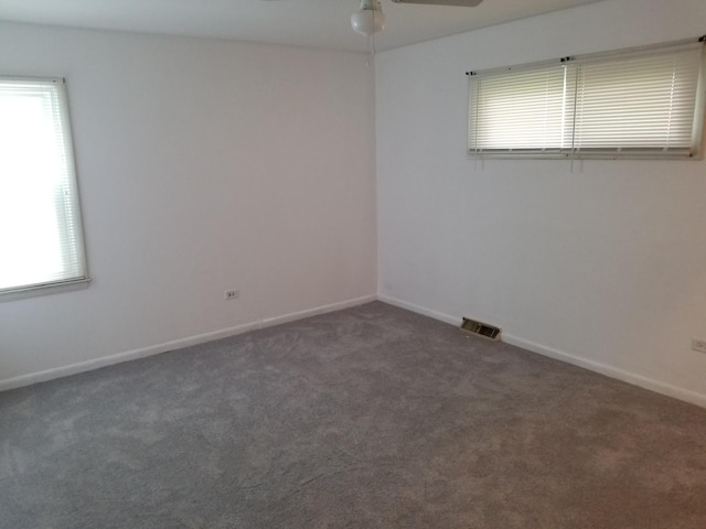 carpeted spare room featuring ceiling fan