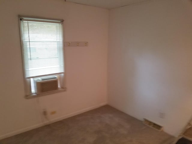 unfurnished room with carpet and cooling unit