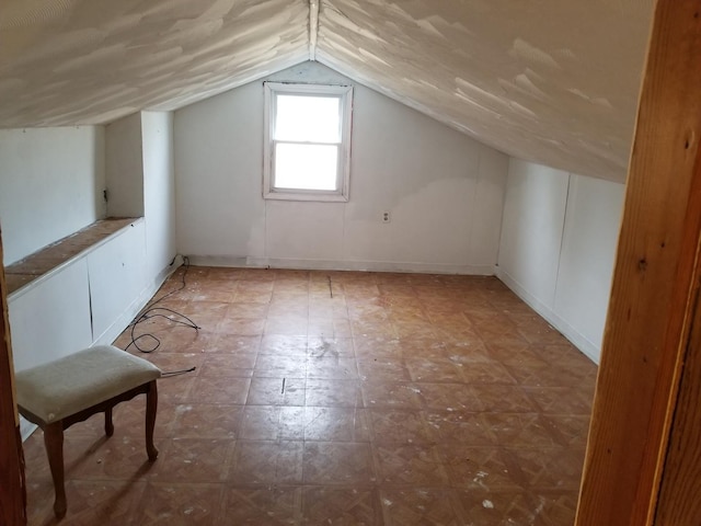 additional living space featuring lofted ceiling