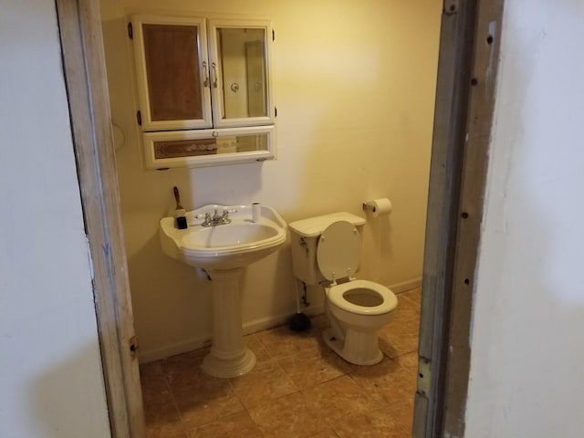 bathroom featuring toilet and sink