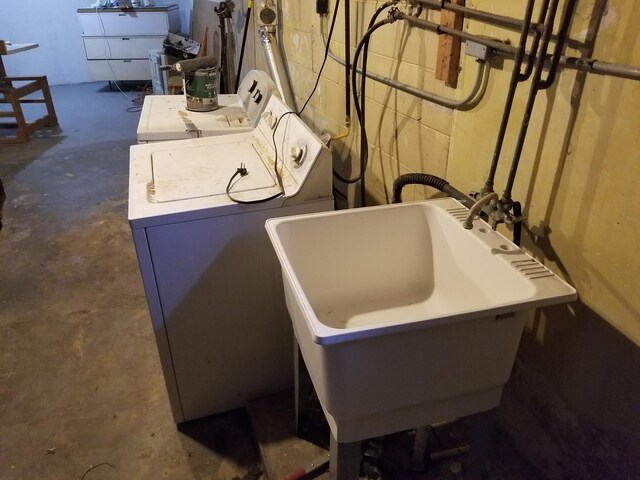 clothes washing area featuring washer and dryer and sink