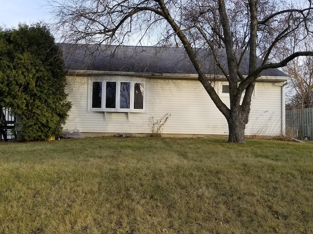 view of side of property featuring a yard