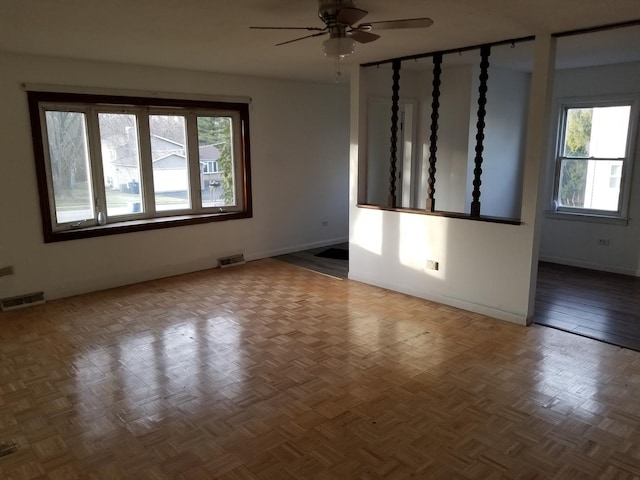 spare room featuring ceiling fan and parquet flooring