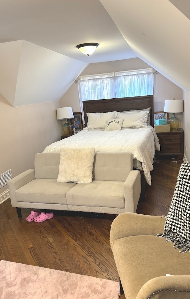 bedroom featuring lofted ceiling and wood-type flooring