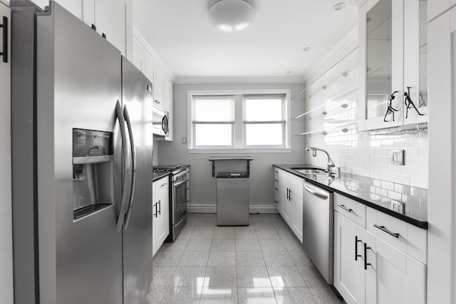 kitchen featuring stainless steel appliances, white cabinets, backsplash, and light tile floors