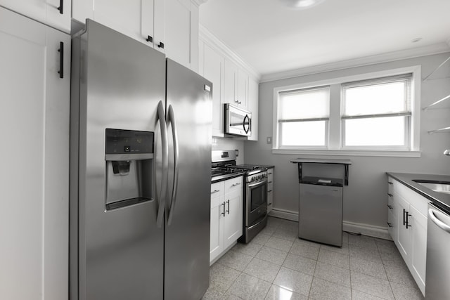 kitchen with crown molding, light tile flooring, white cabinetry, and appliances with stainless steel finishes