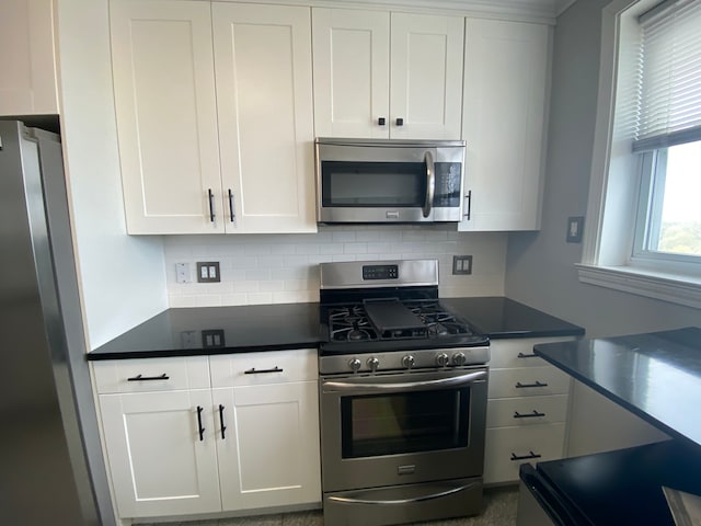 kitchen with white cabinetry, tasteful backsplash, and stainless steel appliances