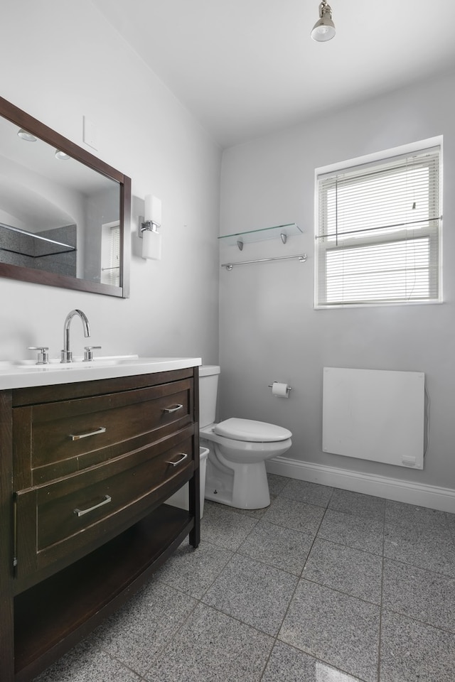 bathroom with tile flooring, vanity, and toilet