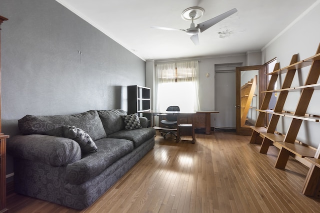 living room featuring ceiling fan, hardwood / wood-style floors, and ornamental molding