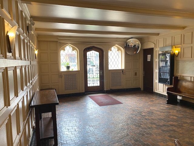 entryway with beam ceiling and ornamental molding