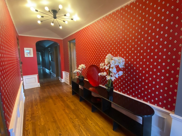 corridor with dark hardwood / wood-style floors and vaulted ceiling