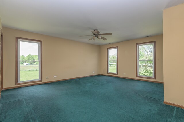 carpeted spare room featuring ceiling fan