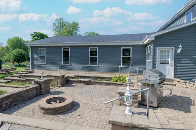 view of terrace with an outdoor fire pit