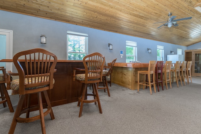 dining space featuring carpet flooring, ceiling fan, a wealth of natural light, and lofted ceiling