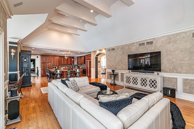 living room with lofted ceiling with beams and light wood-type flooring