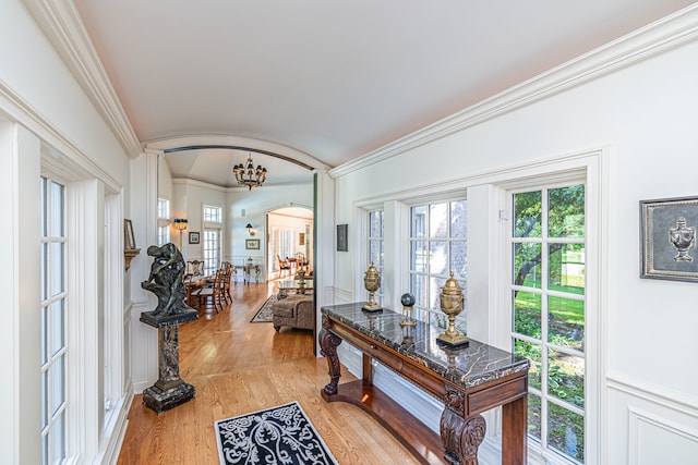 entryway featuring ornamental molding and light hardwood / wood-style floors