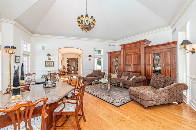 dining space with a chandelier, light hardwood / wood-style flooring, and crown molding