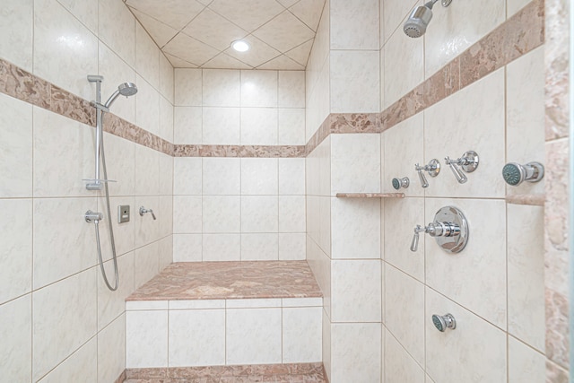 bathroom with a tile shower